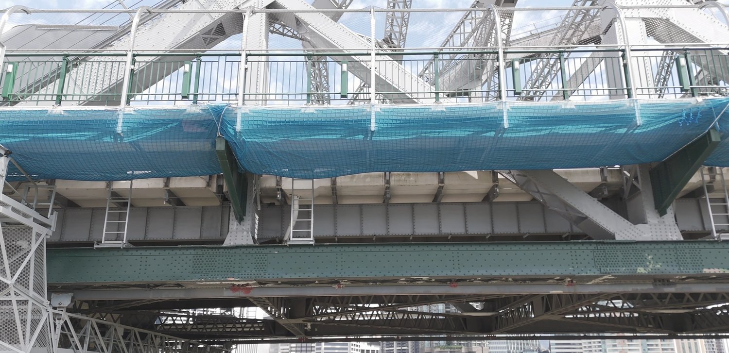 Under-deck view of the Story Bridge with containment netting during a drone inspection